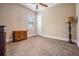 Cozy bedroom with neutral walls, tan carpet, ceiling fan, and plenty of sunlight streaming through the window at 7162 Graybrook Dr, Wesley Chapel, FL 33545