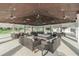 Inviting clubhouse patio with comfortable seating and ceiling fans, perfect for relaxing and socializing at 7162 Graybrook Dr, Wesley Chapel, FL 33545