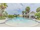 Community pool area with palm trees and a splash fountain, great for Gathering fun in the sun at 7162 Graybrook Dr, Wesley Chapel, FL 33545