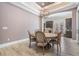 Dining room with wood-look tile floors and modern light fixture at 7162 Graybrook Dr, Wesley Chapel, FL 33545