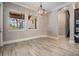 Bright dining room features modern lighting and views of the outdoor living area at 7162 Graybrook Dr, Wesley Chapel, FL 33545