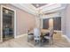 Dining room with wood-look tile floors and modern light fixture at 7162 Graybrook Dr, Wesley Chapel, FL 33545
