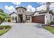 Beautiful home with a stone tower, three car garage, and circular driveway at 7162 Graybrook Dr, Wesley Chapel, FL 33545