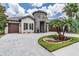 Charming home with a stone tower, three car garage, and beautiful landscaping at 7162 Graybrook Dr, Wesley Chapel, FL 33545