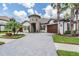 Beautiful home with stone tower, manicured lawn, and a circular driveway for exceptional curb appeal at 7162 Graybrook Dr, Wesley Chapel, FL 33545