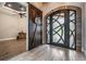 Inviting foyer featuring wood-look tile, decorative front door and rustic sliding barn door at 7162 Graybrook Dr, Wesley Chapel, FL 33545
