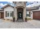 Close up of front exterior featuring a stone tower, arched entrance, and landscaped surroundings at 7162 Graybrook Dr, Wesley Chapel, FL 33545