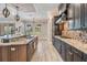 Modern kitchen featuring granite countertops, dark wood cabinets, and stainless steel appliances at 7162 Graybrook Dr, Wesley Chapel, FL 33545