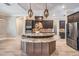 The kitchen has custom cabinets, granite countertops, stainless appliances, mosaic backsplash, and a center island at 7162 Graybrook Dr, Wesley Chapel, FL 33545