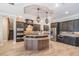 Elegant kitchen with a center island, stainless steel appliances, and custom lighting at 7162 Graybrook Dr, Wesley Chapel, FL 33545