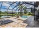 This screened patio includes a pool, spiral staircase, seating, and views of the lake at 7162 Graybrook Dr, Wesley Chapel, FL 33545