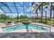 The screened-in pool area features a beautiful view of the lake and includes outdoor seating at 7162 Graybrook Dr, Wesley Chapel, FL 33545
