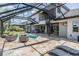 Outdoor living at its finest with a private pool, exterior kitchen, spiral staircase, and lounge chairs at 7162 Graybrook Dr, Wesley Chapel, FL 33545