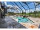 Screened-in pool area with travertine tile, a spiral staircase, and views of a tranquil pond at 7162 Graybrook Dr, Wesley Chapel, FL 33545