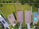High angle view of three homes highlighting roof types, lawn size, and neighboring yards in the community at 8020 Carriage Pointe Dr, Gibsonton, FL 33534