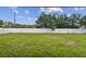 Spacious fenced backyard with green grass and beautiful skies at 8020 Carriage Pointe Dr, Gibsonton, FL 33534