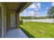 Lush, fenced backyard with a concrete patio, perfect for outdoor enjoyment at 8020 Carriage Pointe Dr, Gibsonton, FL 33534