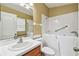 Accessible bathroom with a walk-in tub, grab bars, and a well-lit vanity area at 8020 Carriage Pointe Dr, Gibsonton, FL 33534