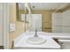 Well-lit bathroom featuring a white sink, vanity, and shower-tub combo at 8020 Carriage Pointe Dr, Gibsonton, FL 33534