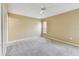Cozy bedroom with a ceiling fan, plush carpet, and a window letting in natural light at 8020 Carriage Pointe Dr, Gibsonton, FL 33534