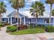 Charming blue community clubhouse featuring ample parking, mature landscaping, and sidewalks at 8020 Carriage Pointe Dr, Gibsonton, FL 33534