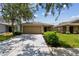 Inviting single-story home with a well-maintained lawn and a two-car garage at 8020 Carriage Pointe Dr, Gibsonton, FL 33534