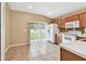 Well-lit kitchen with sliding glass doors leading to the backyard and tile floors at 8020 Carriage Pointe Dr, Gibsonton, FL 33534