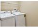Convenient laundry room equipped with white washer and dryer at 8020 Carriage Pointe Dr, Gibsonton, FL 33534