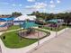 Community playground featuring climbing structures, slides, and shaded seating areas at 8020 Carriage Pointe Dr, Gibsonton, FL 33534