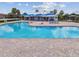 Spacious community pool area with shade structures, lounge seating, and well-maintained landscaping at 8020 Carriage Pointe Dr, Gibsonton, FL 33534