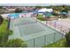 Full tennis court with recreational facilities including a swimming pool and playground in the Gathering-friendly community at 8020 Carriage Pointe Dr, Gibsonton, FL 33534