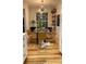 Bright dining room with hardwood floors, modern lighting, and large windows at 824 Lantern Way, Clearwater, FL 33765