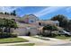 Charming home featuring a symmetrical design, a tile roof, and two-car garage, complemented by well-maintained landscaping at 824 Lantern Way, Clearwater, FL 33765