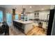Bright kitchen features a large marble island, stainless steel appliances, and hardwood floors at 824 Lantern Way, Clearwater, FL 33765