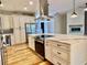 Bright kitchen featuring a center island with a range, stainless steel appliances, and modern finishes at 824 Lantern Way, Clearwater, FL 33765