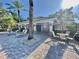 Community poolside lounge area featuring multiple chairs and tables, set amid mature palms at 824 Lantern Way, Clearwater, FL 33765