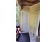 Covered back door leading into the property with a cream exterior and a storage rack on the tile at 8630 Mallard Reserve Dr # 105, Tampa, FL 33614