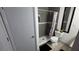 Bathroom with a toilet, sink with granite counters, and a shower with gray tiling at 8630 Mallard Reserve Dr # 105, Tampa, FL 33614