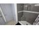 Shower stall with gray tiling and a built in seat. Shower also includes a gray door for privacy at 8630 Mallard Reserve Dr # 105, Tampa, FL 33614