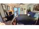 Spacious bedroom with wood flooring, a ceiling fan, a full bed and a mounted TV at 8630 Mallard Reserve Dr # 105, Tampa, FL 33614