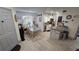 Open floor plan with kitchen island and dining area with charming decor and wood-look tile flooring at 8630 Mallard Reserve Dr # 105, Tampa, FL 33614