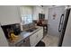 The kitchen has stainless steel appliances, granite countertops, and white cabinetry at 8630 Mallard Reserve Dr # 105, Tampa, FL 33614