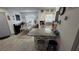 A view of the kitchen and dining area, with a granite island and stainless steel appliances at 8630 Mallard Reserve Dr # 105, Tampa, FL 33614