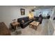 A well decorated living room with two leather couches, side tables, and tile flooring at 8630 Mallard Reserve Dr # 105, Tampa, FL 33614