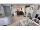 Open floor plan of kitchen island leading to the living room with wood look flooring at 8630 Mallard Reserve Dr # 105, Tampa, FL 33614