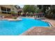 Community swimming pool with lounge chairs, a gazebo and landscaping surrounding the pool area at 8630 Mallard Reserve Dr # 105, Tampa, FL 33614