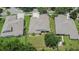 An aerial view of a well-maintained property featuring a manicured lawn and lush landscaping at 8704 Winsome Way, Land O Lakes, FL 34637