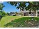 Aerial view of a large private green fenced in backyard and house with a screened-in porch at 8704 Winsome Way, Land O Lakes, FL 34637