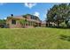 Expansive backyard featuring lush lawn and mature trees, perfect for outdoor activities and relaxation at 8704 Winsome Way, Land O Lakes, FL 34637