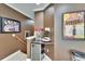 Basement bar area complete with a mini fridge, popcorn machine, and movie poster decor at 8704 Winsome Way, Land O Lakes, FL 34637